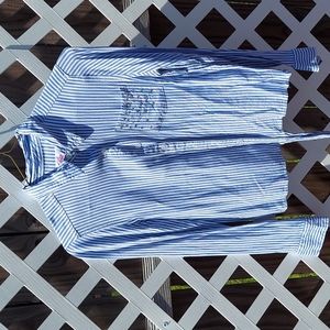 A blue and white striped long sleeve button up shirt with a bedazzled pocket.b